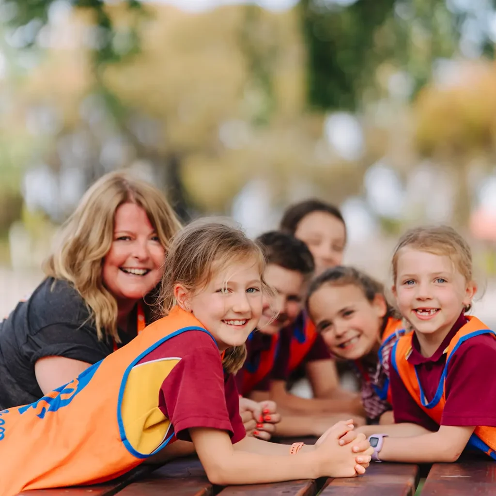 TeamKids educator with children enjoying an outdoor activity